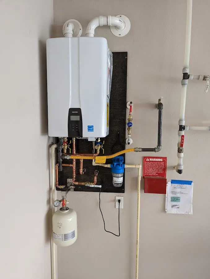 Professional plumber installing copper piping in a Sparta home